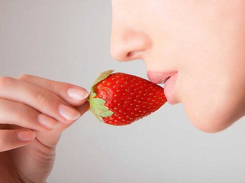 Person Eating Strawberry