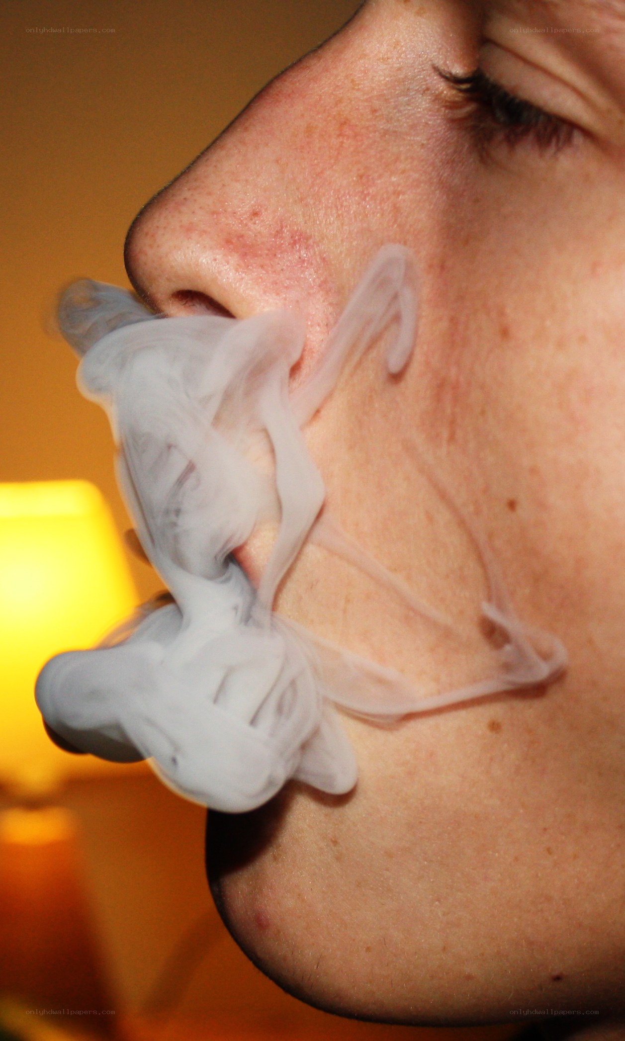 person exhaling smoke