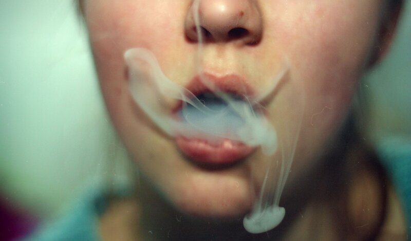 person exhaling smoke