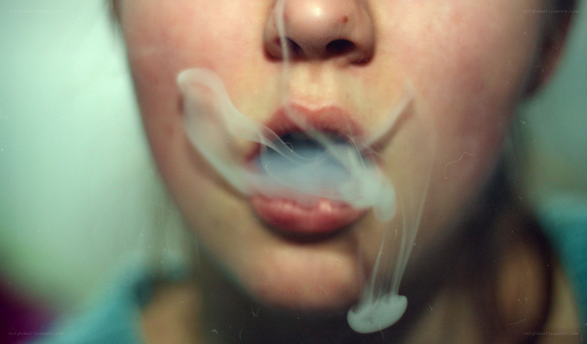 person exhaling smoke