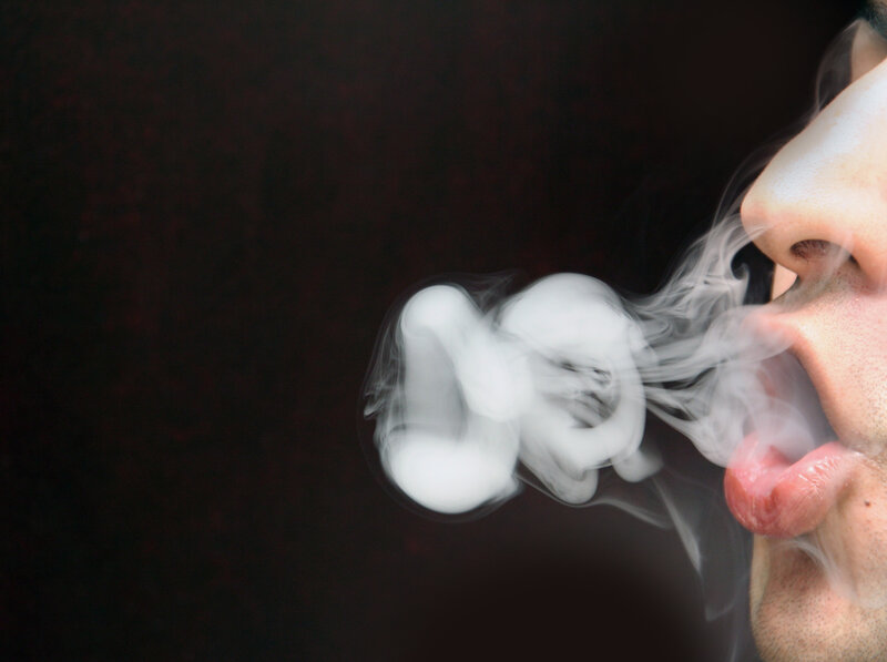 Person Exhaling Smoke — White