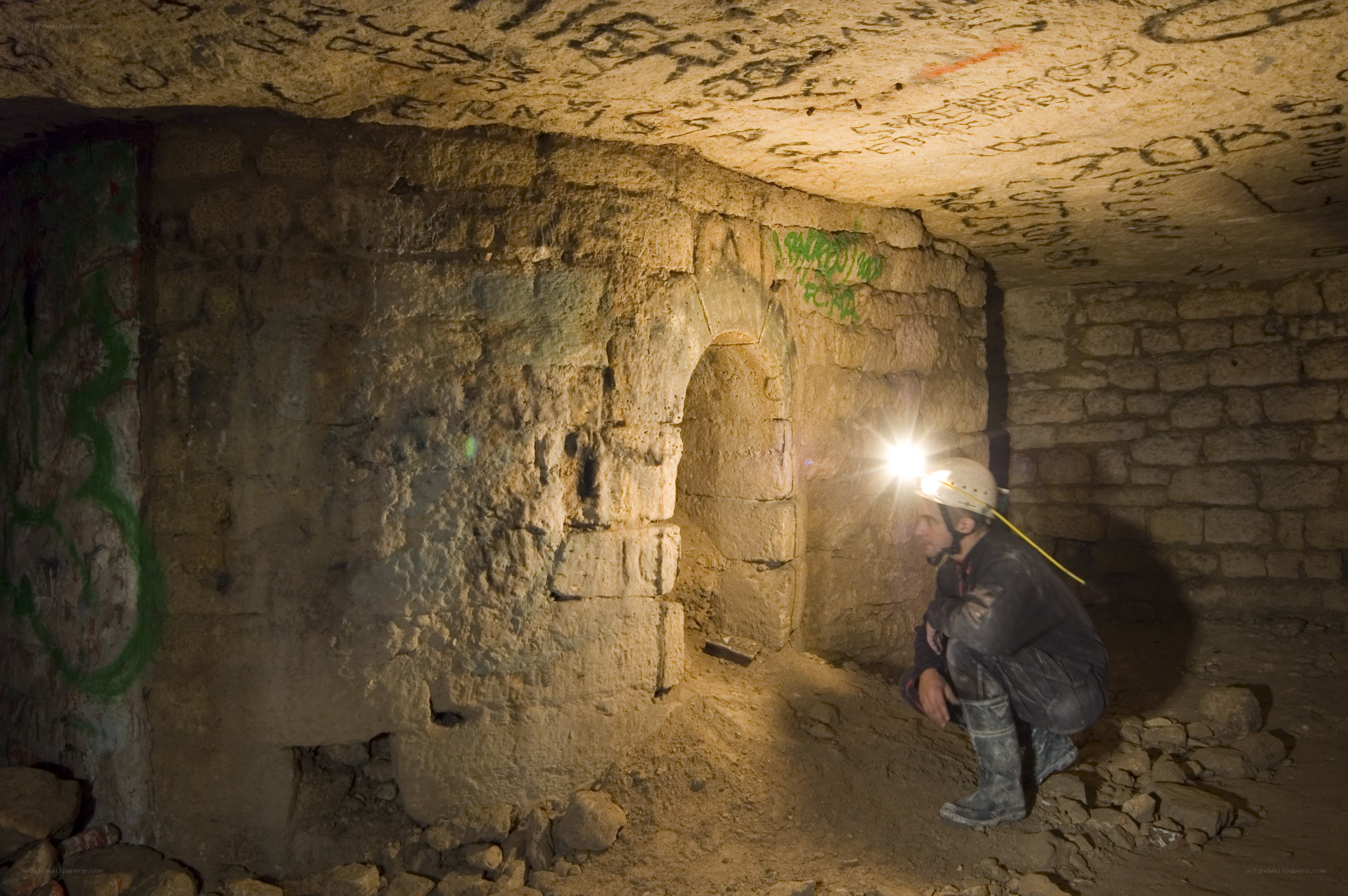 Person exploring underground tunnel