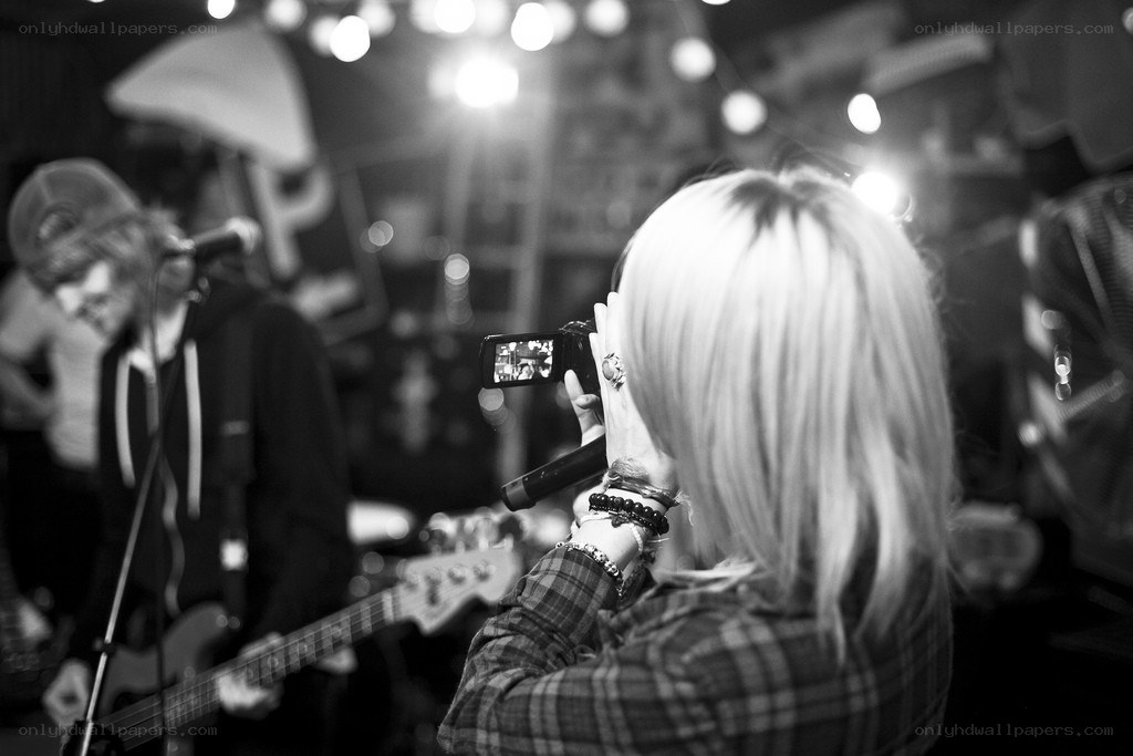 Person filming band performance