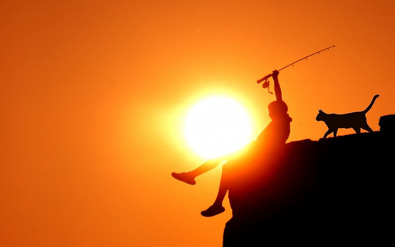 Person Fishing at Sunset — Orange, Serene
