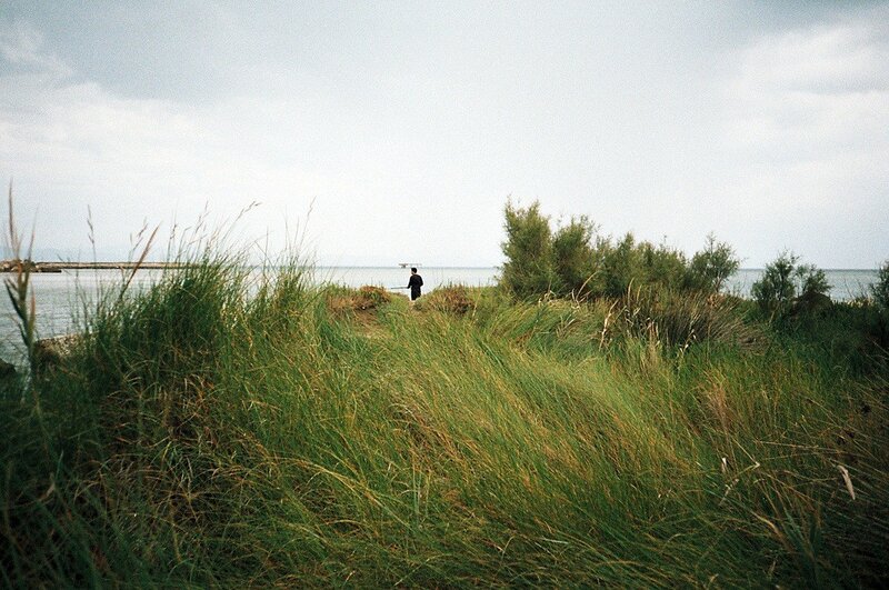 Person fishing by the sea
