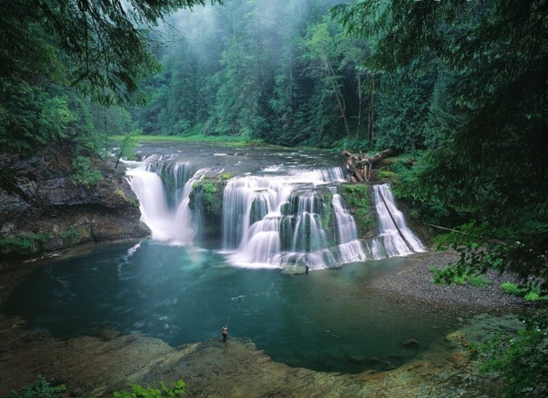 Person Fishing by Waterfall