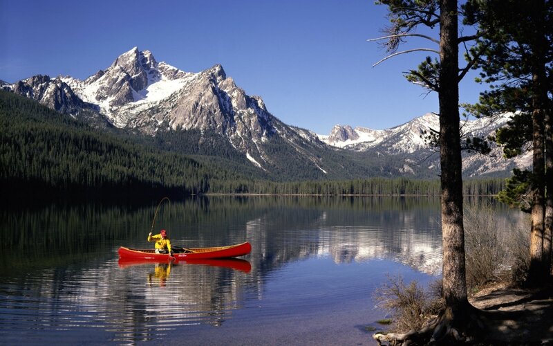 Person Fishing in Canoe — Blue