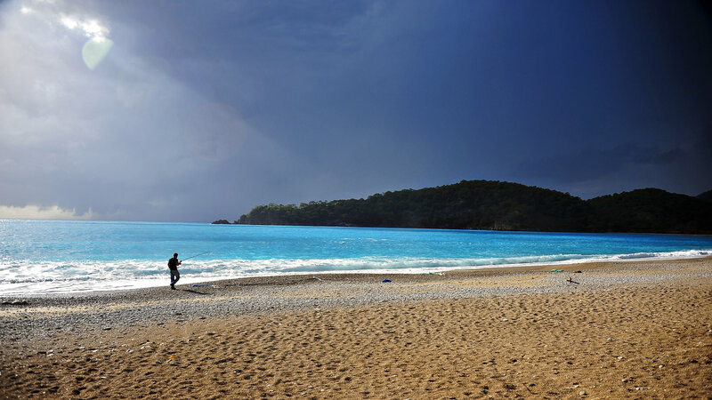 Person Fishing on Beach — Blue, Dramatic, Afternoon