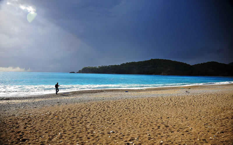 Person Fishing on Beach — Blue, Dramatic