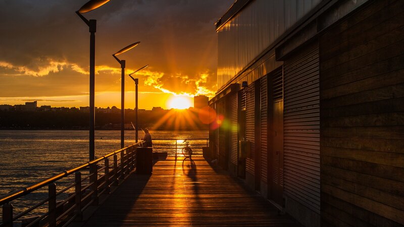 Person Fishing on Pier — Orange
