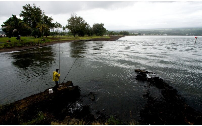 Person Fishing on Rocks