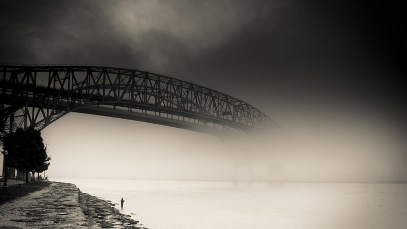 Person Fishing under Bridge