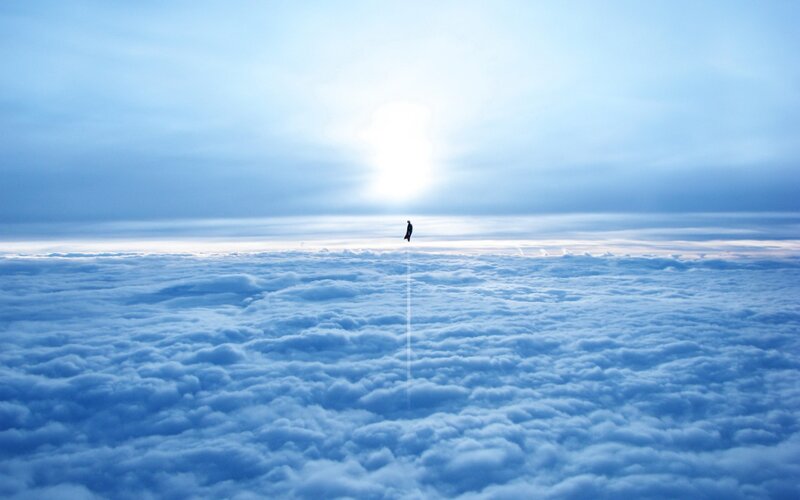 Person Floating Above Clouds
