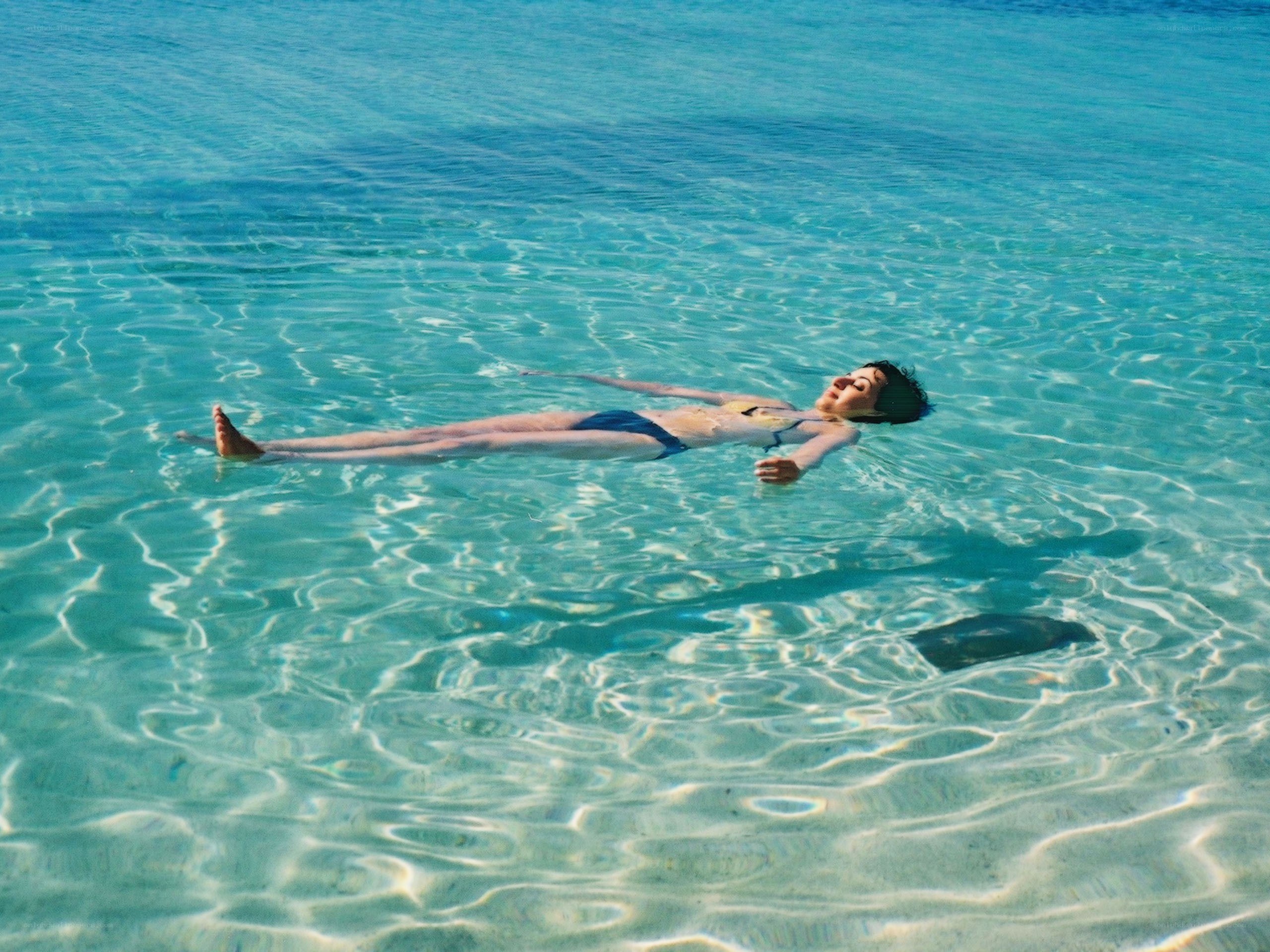 Person floating in clear water