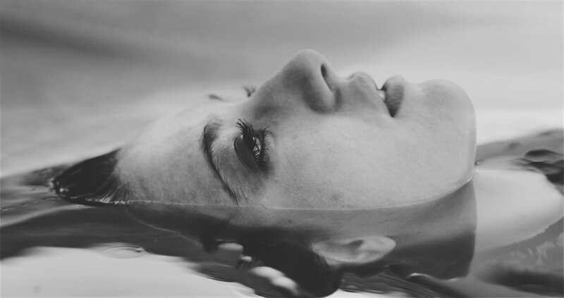 Person Floating in Water — Black, Serene