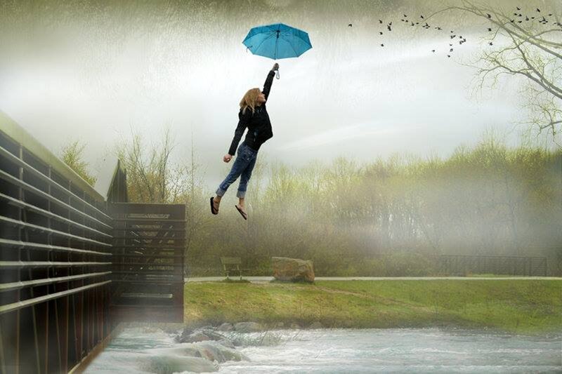 Person Floating with Umbrella