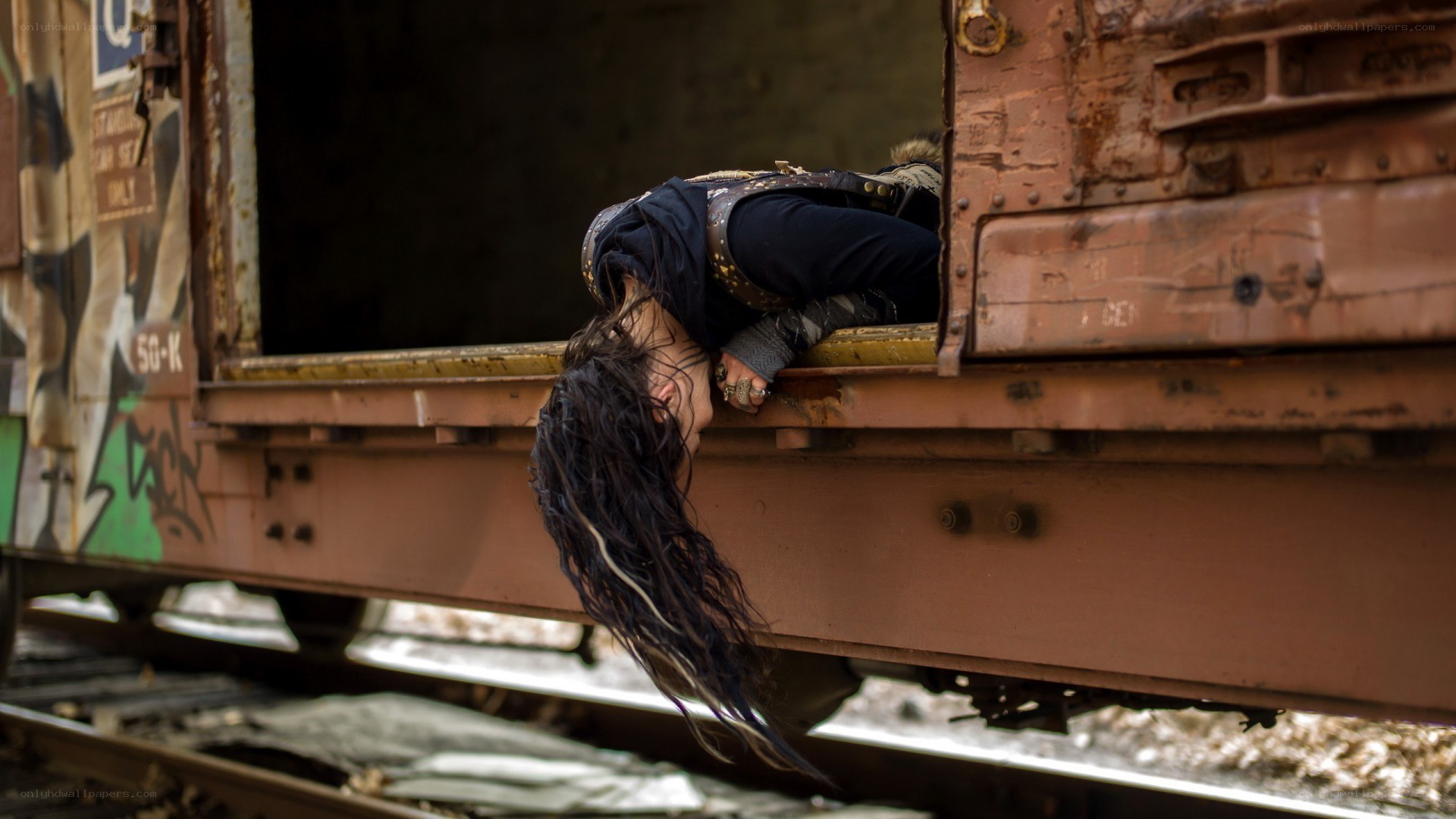 Person hanging from train car