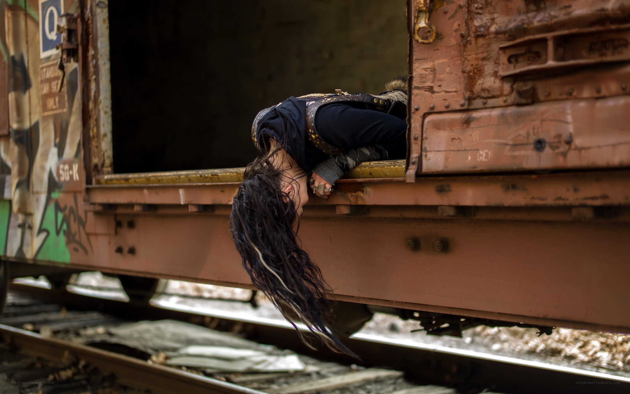 Person hanging from train car