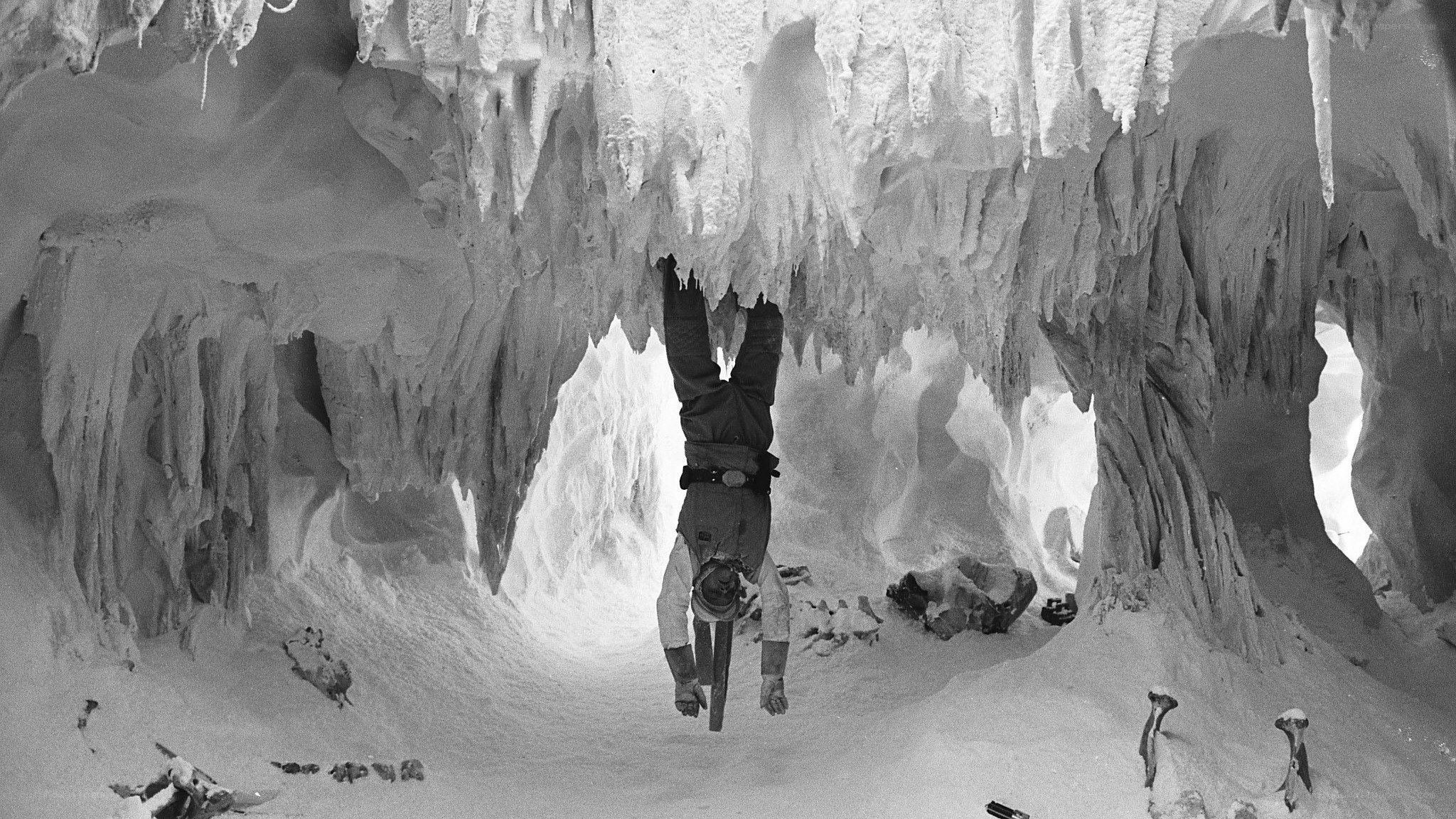 Person hanging upside down in cave