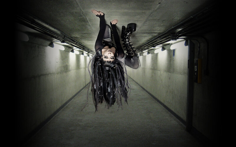 person hanging upside down in tunnel