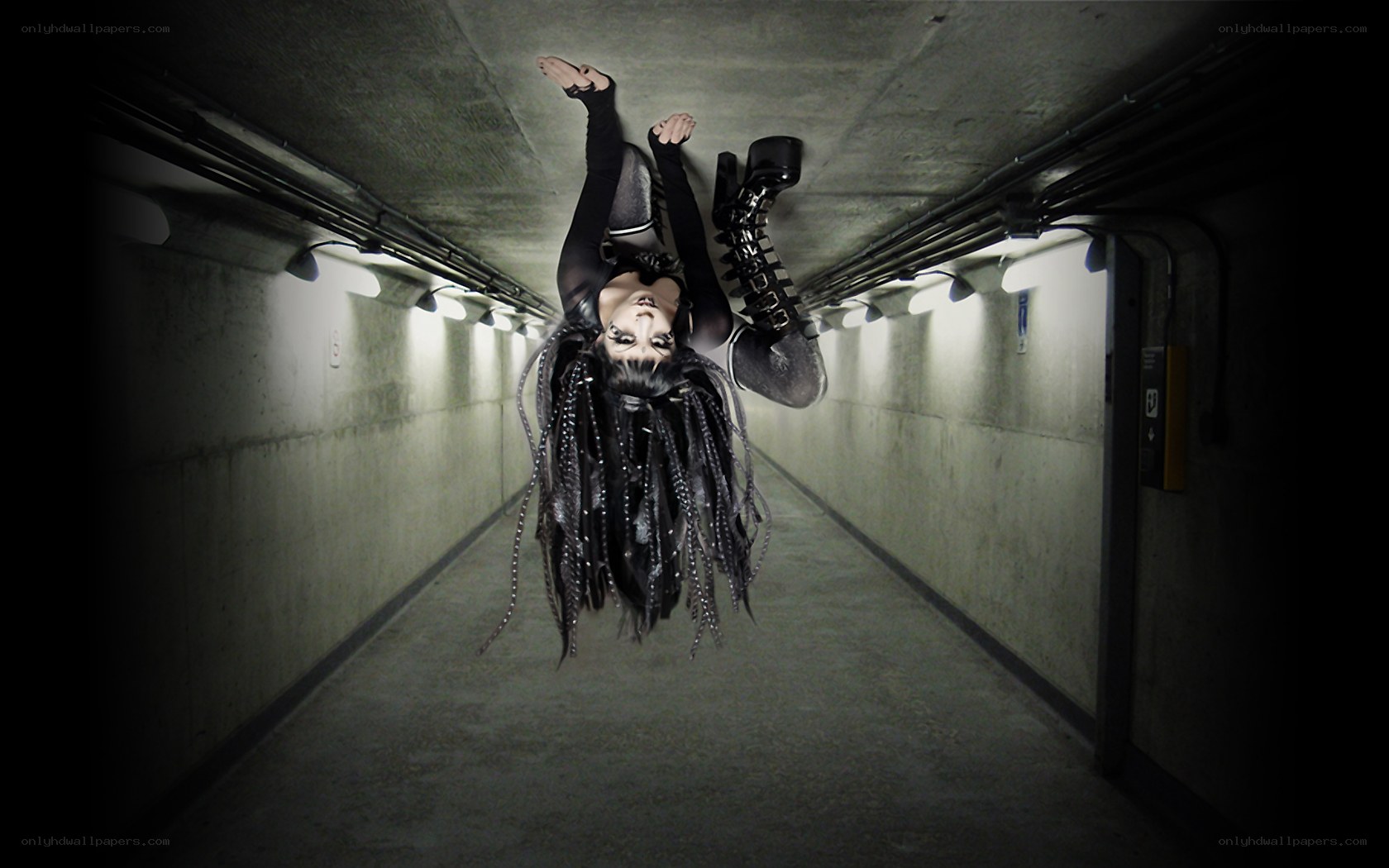 person hanging upside down in tunnel