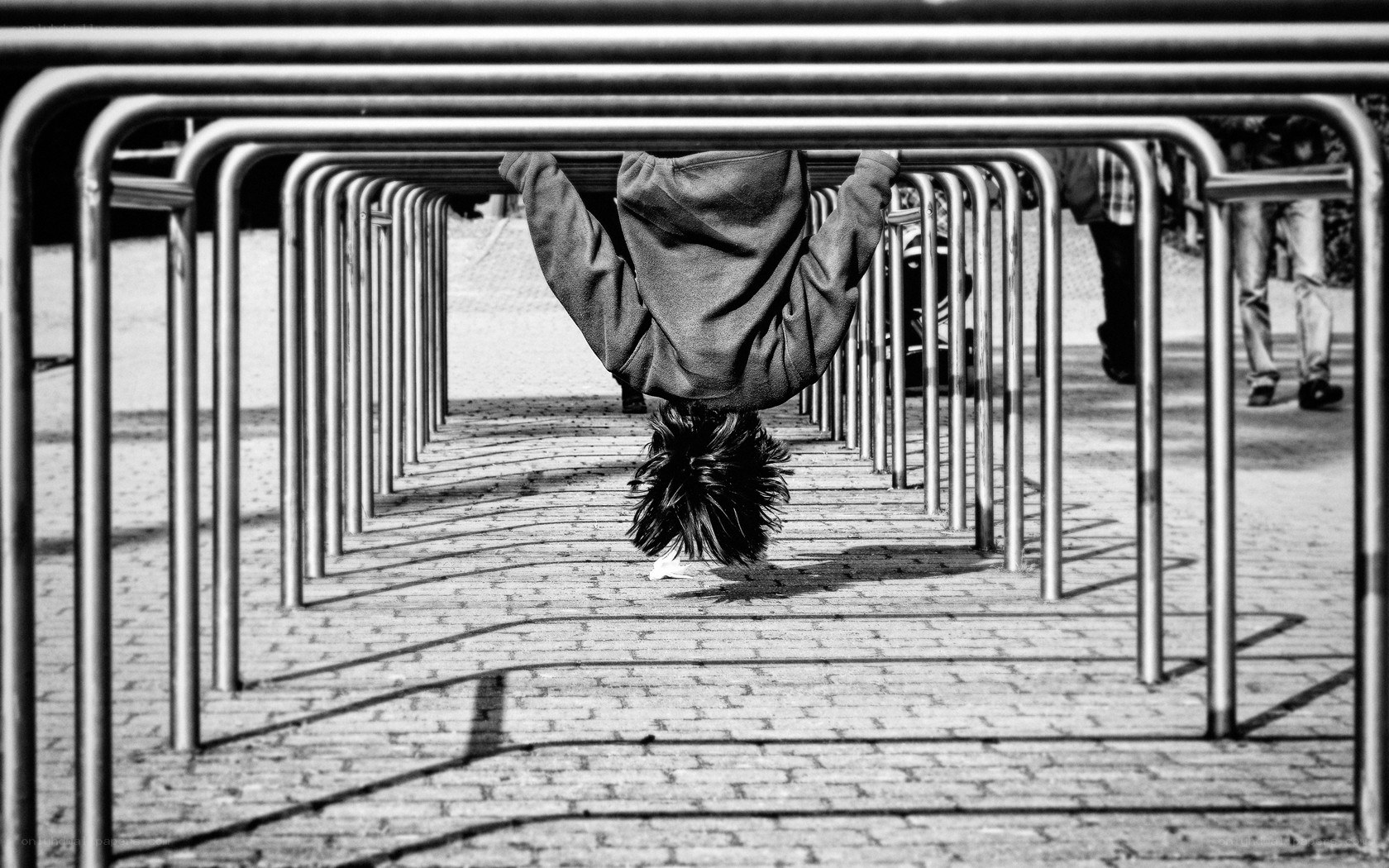 Person hanging upside down under railings
