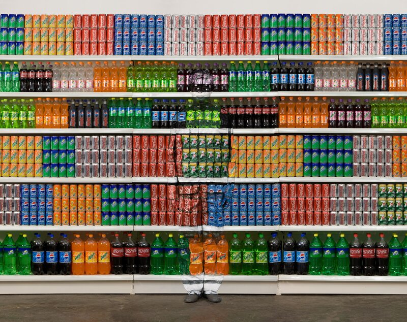 person hidden behind soda shelves