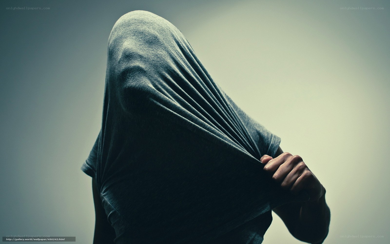 person hiding under a shirt