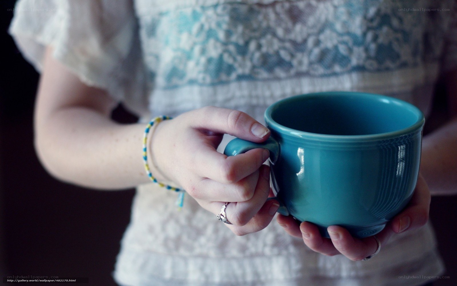 person holding a blue mug