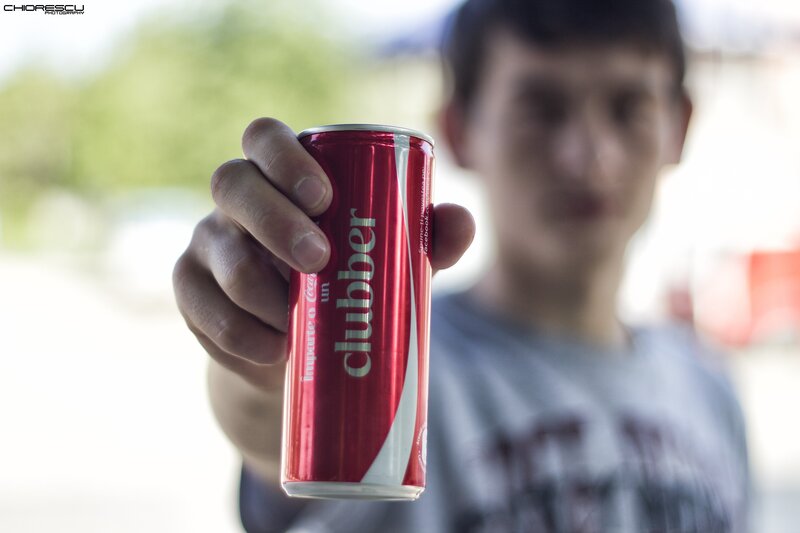person holding a clubber soda can