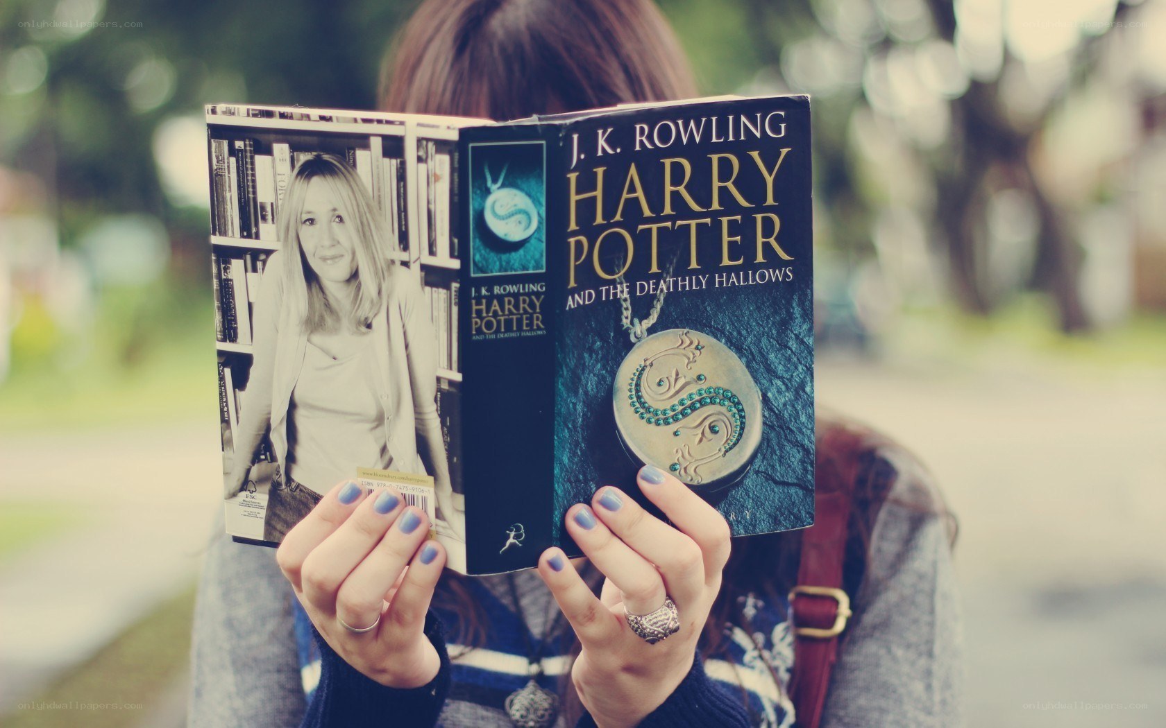 person holding a harry potter book