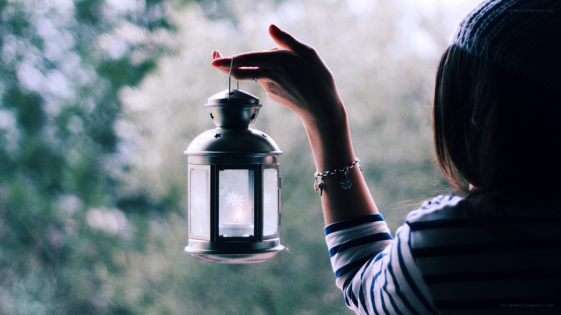 person holding a lantern