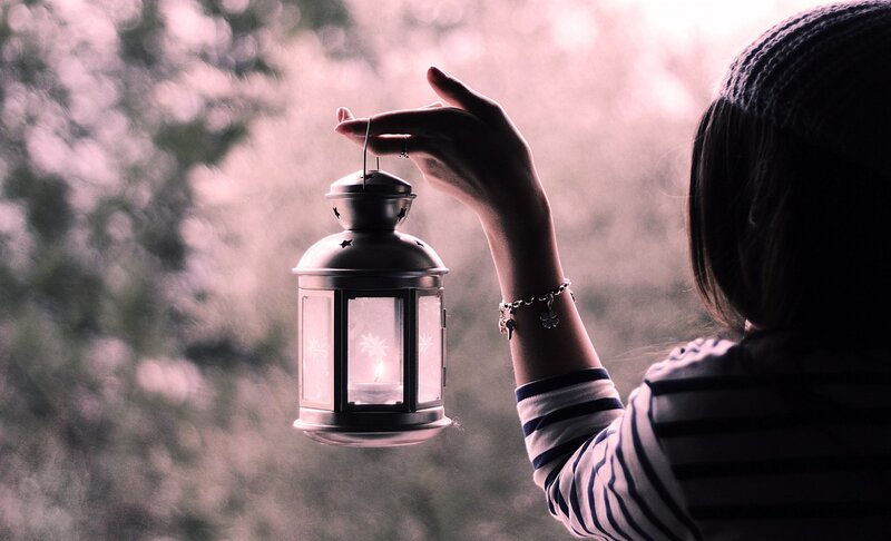 person holding a lantern