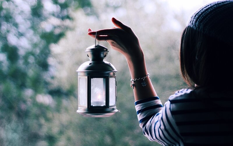 person holding a lantern