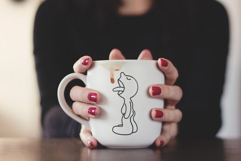 person holding a mug