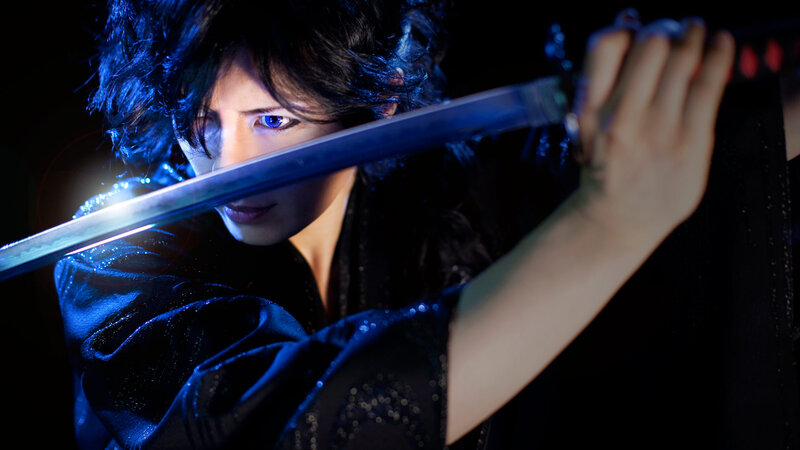 Person Holding a Sword — Black, Dramatic