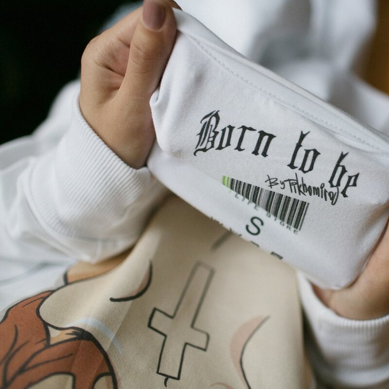 person holding a white pouch