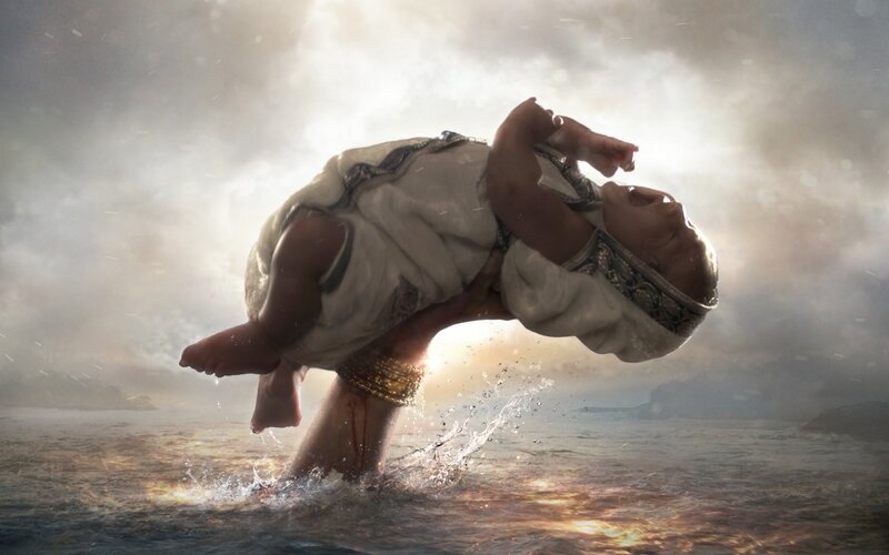 Person Holding Baby in Water
