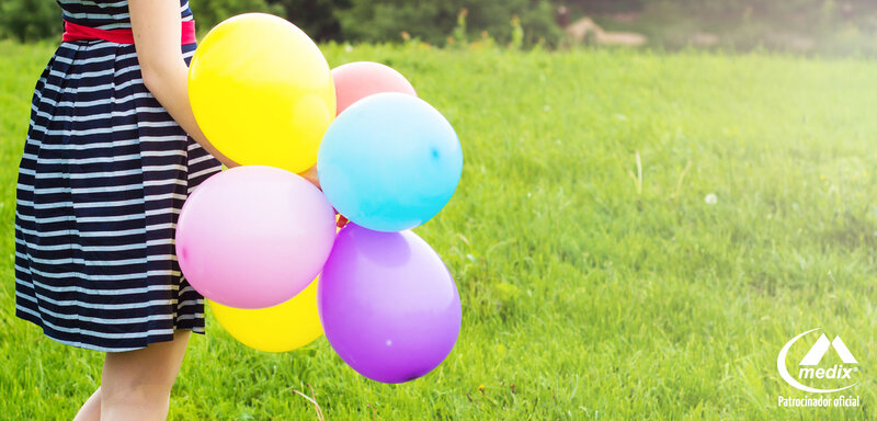 Person Holding Balloons — Green