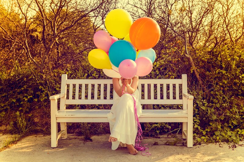 Person Holding Balloons — White, Serene