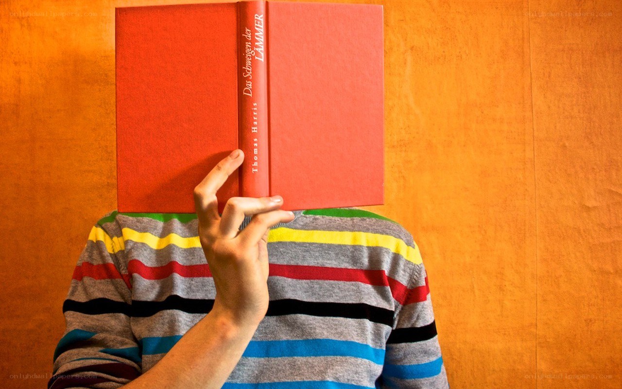 person holding book over face