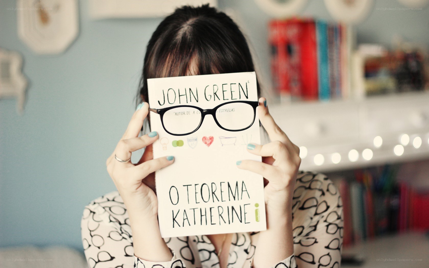 person holding book with face covered