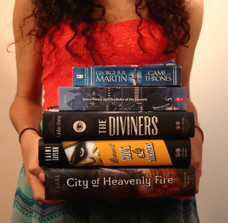 Person Holding Books — Red
