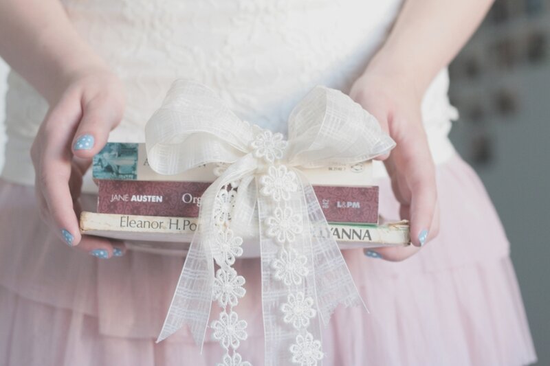 Person Holding Books — White