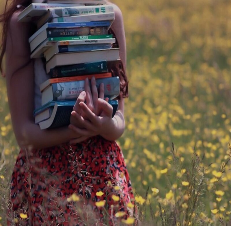 Person Holding Books — Yellow