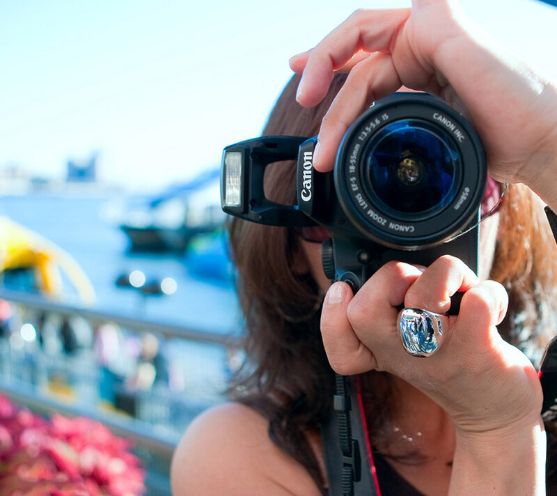Person Holding Camera — Blue