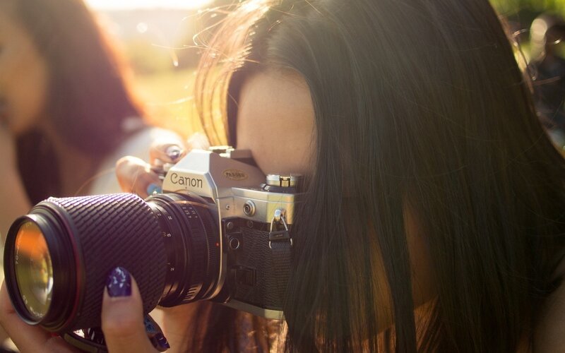Person Holding Camera — Brown, Warm