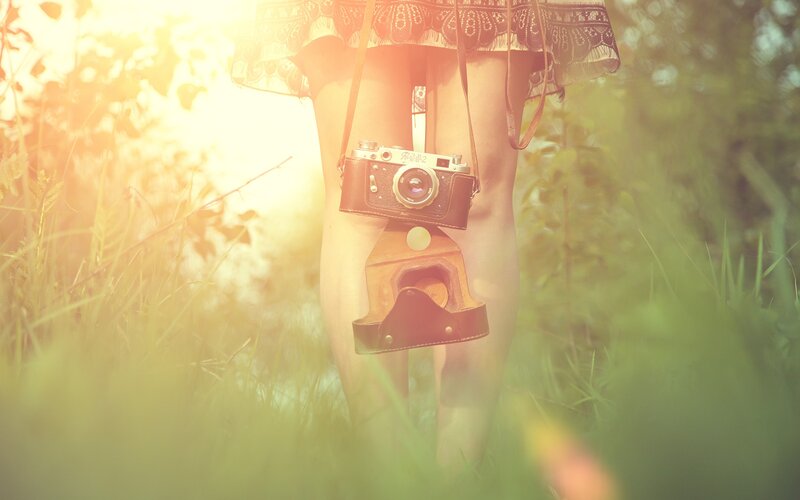 Person Holding Camera — Green, Serene, Sunset
