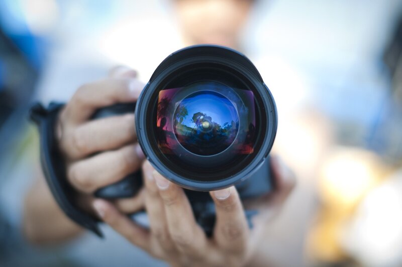 Person Holding Camera Lens