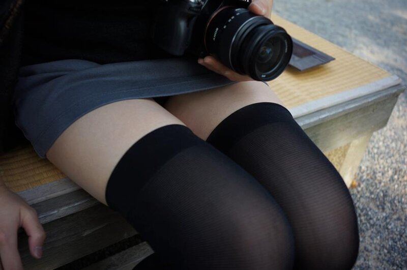 person holding camera on bench